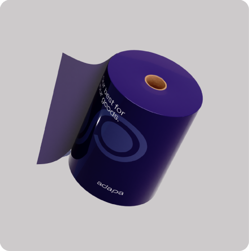A large roll of dark purple flexible packaging film with a brown cardboard core, floating at an angle against a light gray background. The glossy material features a darker purple circular design, the white adapa brand logo, and the white text slogan "Our best for your goods."